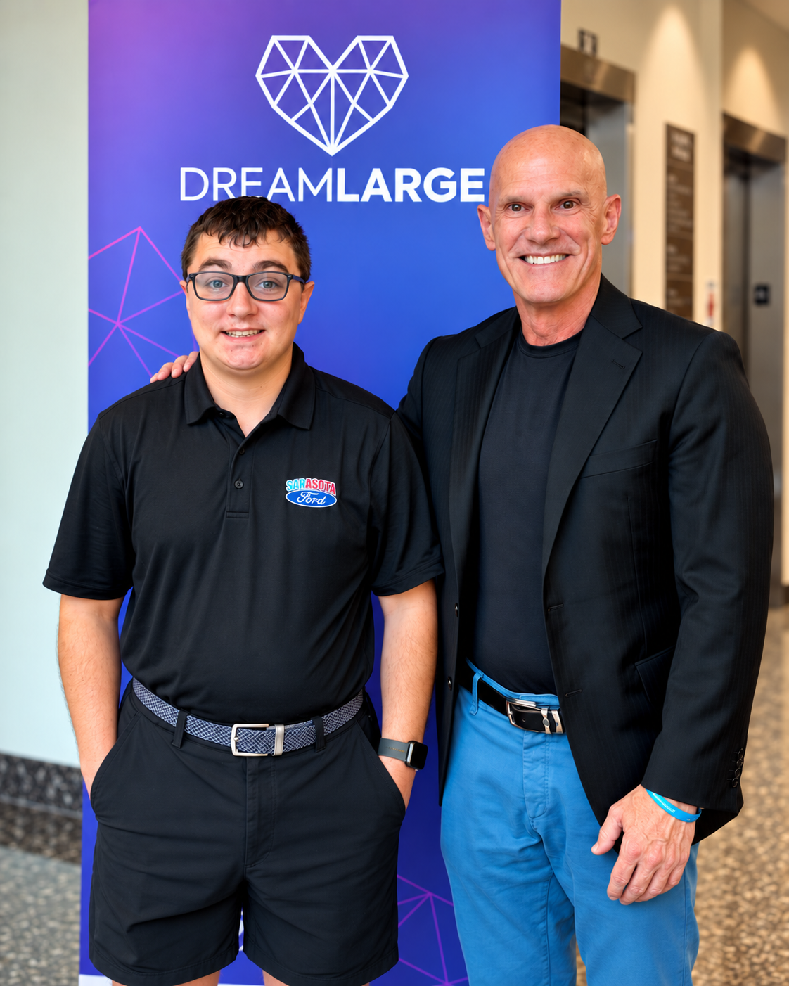 Nick and Beaver Shriver standing together in front of a DreamLarge backdrop